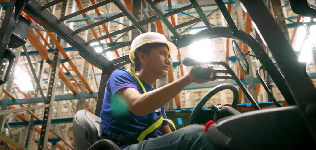 warehouse personnel manning a forklift