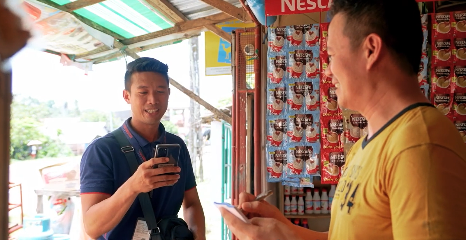 a sales representative from a selling and distribution company in the philippines offers new FMCG products to a sari-sari store owner