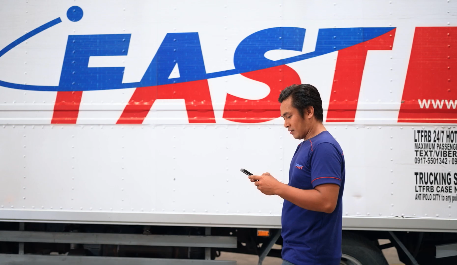 fast employee using a mobile phone to access Driver app, which is part of Transport Management System